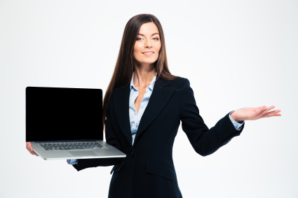 Happy businesswoman showing blank laptop screen and holding copyspace on the palm isolated on a white background. Looking at camera