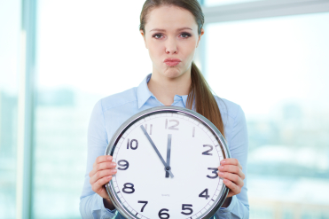 Conceptual portrait of a business lady with clock being short of time